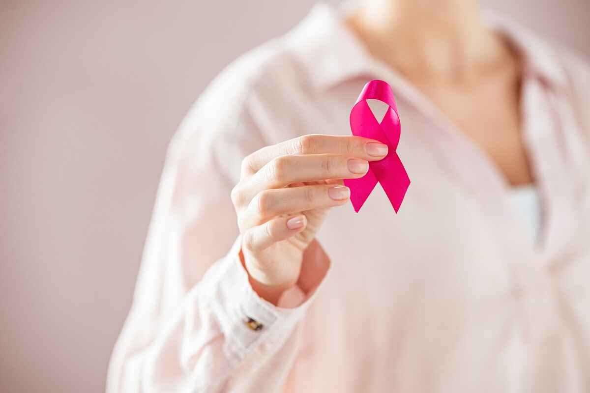 Woman holds breast cancer awareness ribbon