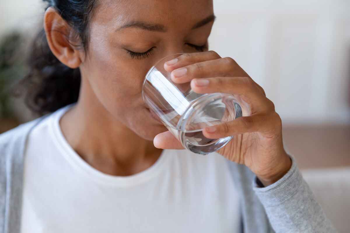 Woman drinks water to get hydrated